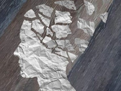 Monográfico: Amnesia retrógrada y daño cerebral Imagen que representa la amnesia, con una silueta de una cabeza humana recortada en papel con la zona craneal rota en pedazos