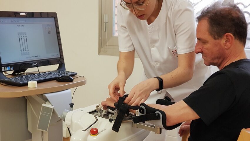 Rehabilitación robótica del miembro superior: innovación funcional en evolución Terapeuta batek paziente baten eskua Amadeo robotean jarriko du goiko gorputz-adarraren errehabilitazio-saio batean